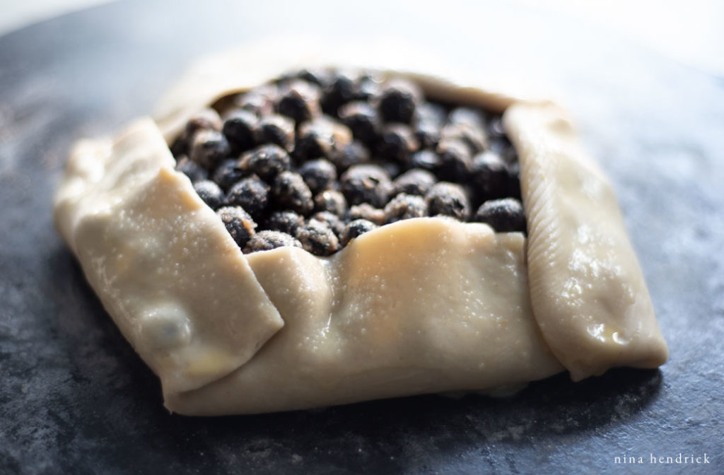 uncooked blueberry galette with egg wash