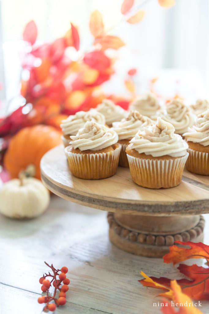 Cupcakes on a cake stand with pumpkins and leaves