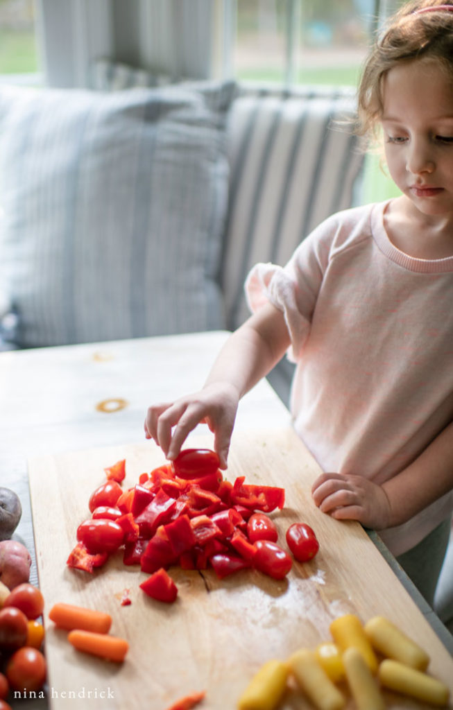 child sorting vegetables by color